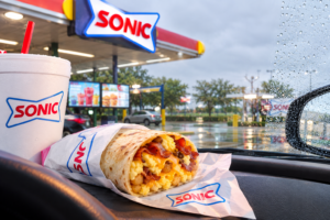 Sonic breakfast burrito and drink at a Sonic Drive-In restaurant on a rainy day.